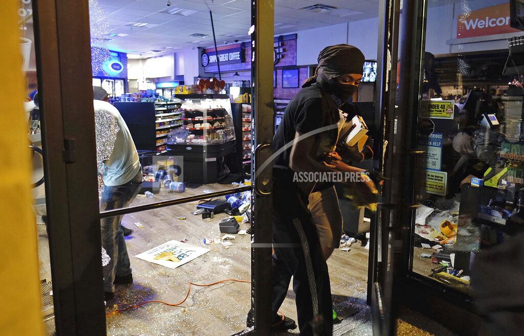 Ben Gray In this May 29, 2020, photo, people leave a damaged store during protests in Atlanta, Georgia. Protests have been erupting all over the country after George Floyd died earlier this week in police custody in Minneapolis. (Ben Gray/Atlanta Journal-Constitution via AP)
