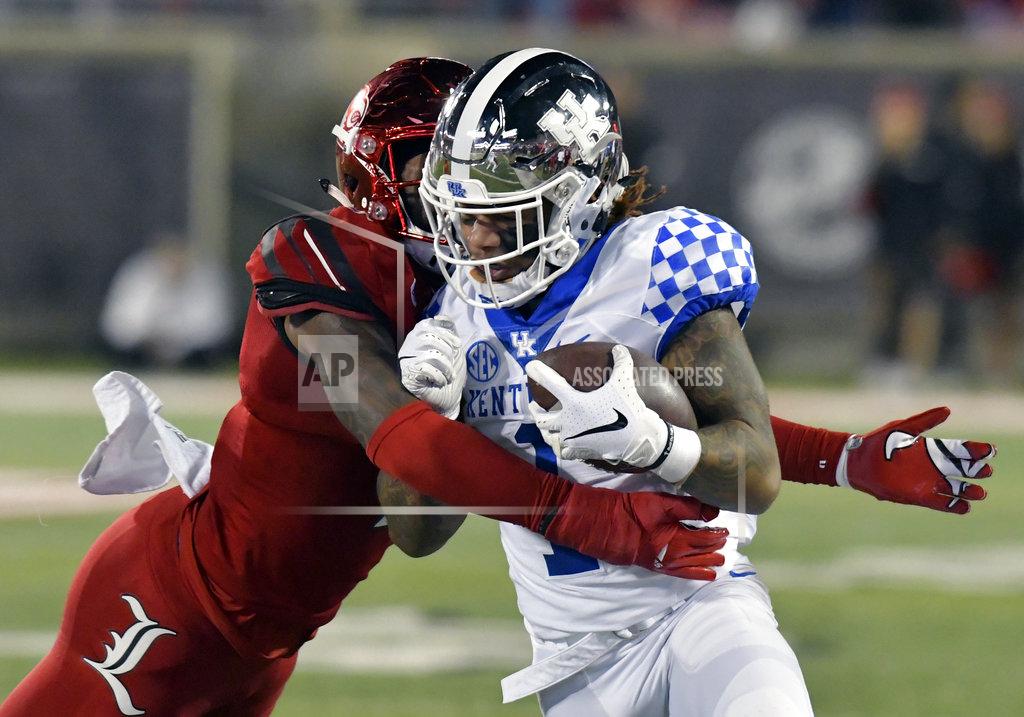 Timothy D. Easley Kentucky wide receiver Lynn Bowden Jr. (1) is hit by Louisville linebacker C.J. Avery during the first half of an NCAA college football game in Louisville, Ky., Saturday, Nov. 24, 2018. (AP Photo/Timothy D. Easley)