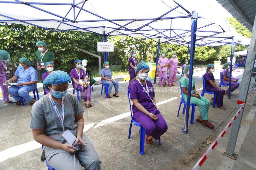 Thein Zaw In this Jan. 27, 2021, file photo, Health workers wait to receive the Covishield COVID-19 vaccine at the Ayeyarwaddy COVID treatment center in Yangon, Myanmar. Medical workers across Myanmar have begun a civil disobedience protest against Monday, Feb. 1, 2021's coup, pinning red ribbons and declaring they won’t work for the military government.(AP Photo/Thein Zaw, File)