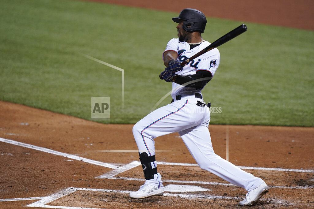 FILE - In this Sept. 2, 2020, file photo, Miami Marlins' Starling Marte bats during the third inning of the team's baseball game against the Toronto Blue Jays in Miami. Marte is staying with the Marlins after the team exercised its $12.5 million contract option for next year. Miami decided to pick up Marte’s option rather than pay him a $1 million buyout. The move Tuesday, Oct. 27, prevents Marte from becoming a free agent this offseason. (AP Photo/Wilfredo Lee, File)