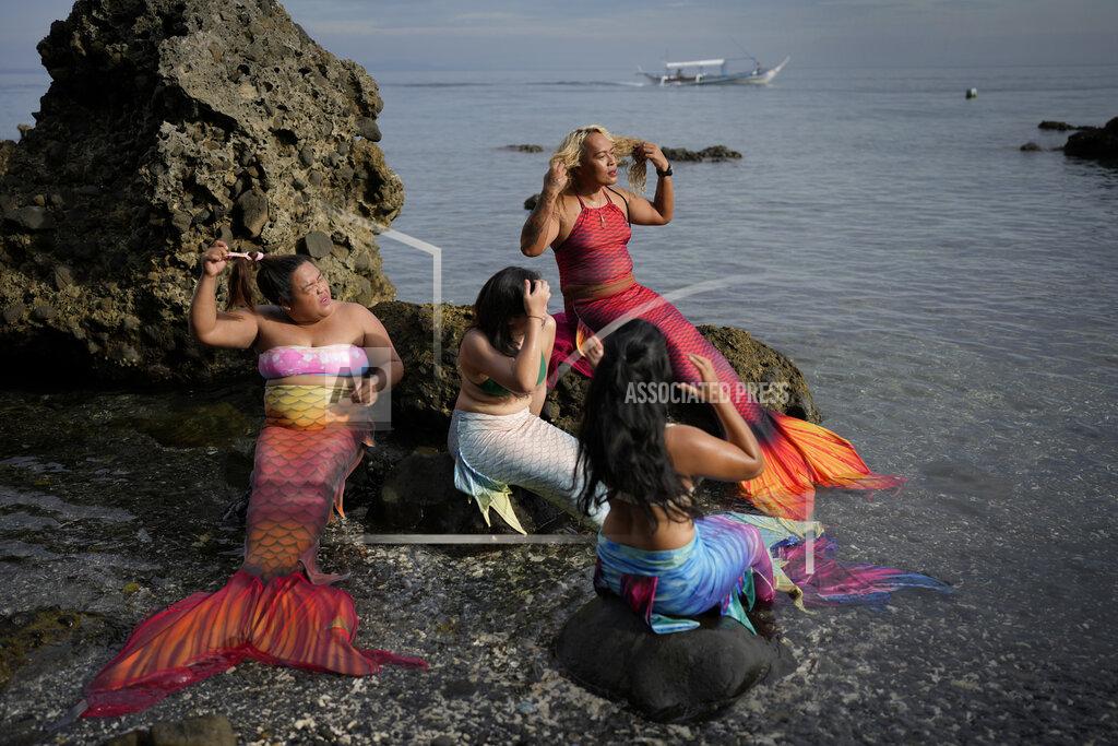 Aaron Favila Queen Pangke Tabora, right, and her students prepare for a mermaiding class at the Ocean Camp in Mabini, Batangas province, Philippines on Sunday, May 22, 2022. (AP Photo/Aaron Favila)