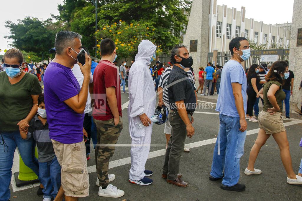 Angel Dejesus Voters line up outside the Vicente Rocafuerte school during general elections in Guayaquil, Ecuador, Sunday, Feb. 7, 2021. Ecuadoreans went to the polls in first-round presidential legislative elections. (AP Photo/Angel Dejesus)