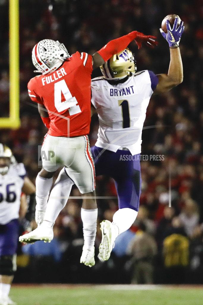 Jae C. Hong Washington tight end Hunter Bryant, right, catches a pass next to Ohio State safety Jordan Fuller during the second half of the Rose Bowl NCAA college football game Tuesday, Jan. 1, 2019, in Pasadena, Calif. (AP Photo/Jae C. Hong)