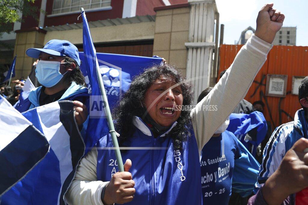 Martin Mejia Supporters of presidential candidate Luis Arce shout slogans outside his headquarters one day after elections in La Paz, Bolivia, Monday, Oct. 19, 2020. Evo Morales' party, with Arce as its candidate, claimed victory in a presidential election that appeared to reject the right-wing policies of the interim government that took power in Bolivia after the leftist leader resigned and fled the country a year ago. (AP Photo/Martin Mejia)