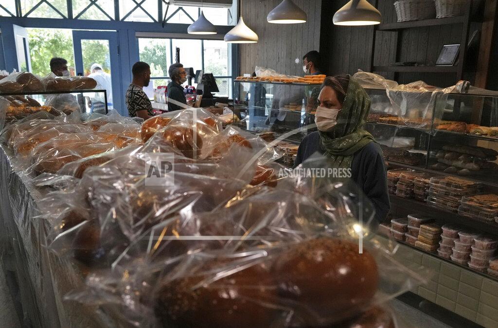 Vahid Salemi A customer looks at display cases in a bakery in Tehran, Iran, Wednesday, May 11, 2022. Iran abruptly raised prices as much as 300% for a variety of staples such as cooking oil, chicken, eggs and milk on Thursday. (AP Photo/Vahid Salemi)