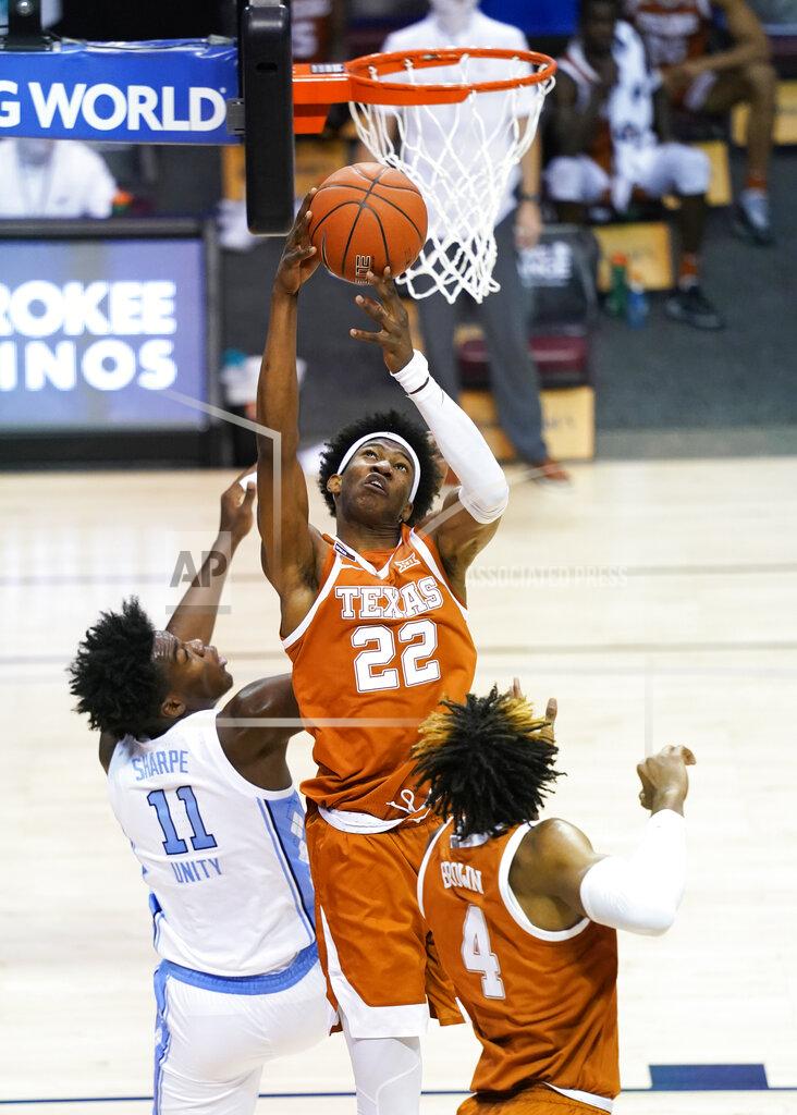 Kathy Kmonicek Texas forward Kai Jones (22) grabs a rebound over North Carolina forward Day'Ron Sharpe (11) in the first half of an NCAA college basketball game for the championship of the Maui Invitational, Wednesday, Dec. 2, 2020, in Asheville, N.C. (AP Photo/Kathy Kmonicek)