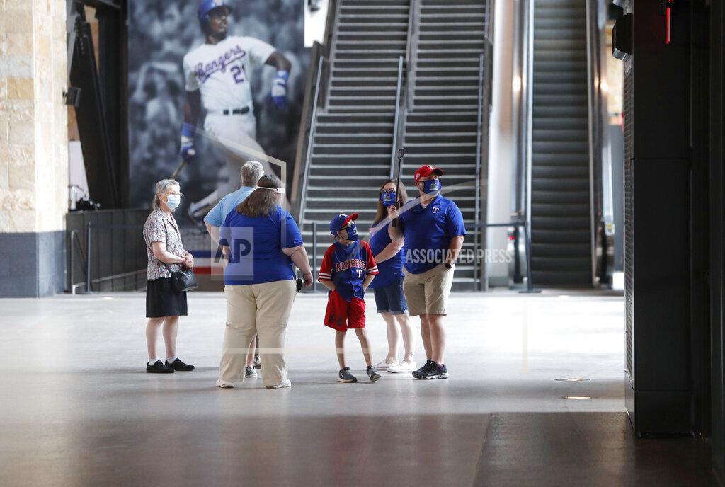 Lm Otero Baseball fans check out the concourse at Globe Life Field, the new home of the Texas Rangers baseball team, during the first day of public tours Monday, June 1, 2020, in Arlington, Texas. As lock-downs are lifted, restrictions on social gatherings eased and life begins to resemble some sense, sports are finally starting to emerge from the coronavirus pandemic. Major League Soccer, the NBA and NHL have agreements in place to restart their seasons, and baseball is going through contentious rounds of negotiations over what it might take for umpires to cry “Play Ball!” and America's pastime to provide a weary public some much-needed entertainment.(AP Photo/LM Otero, File)