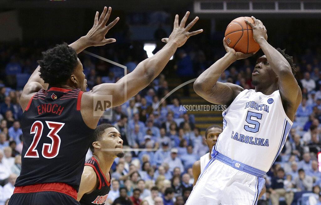 Gerry Broome North Carolina's Nassir Little (5) shoots over Louisville's Steven Enoch (23) during the first half of an NCAA college basketball game in Chapel Hill, N.C., Saturday, Jan. 12, 2019. (AP Photo/Gerry Broome)