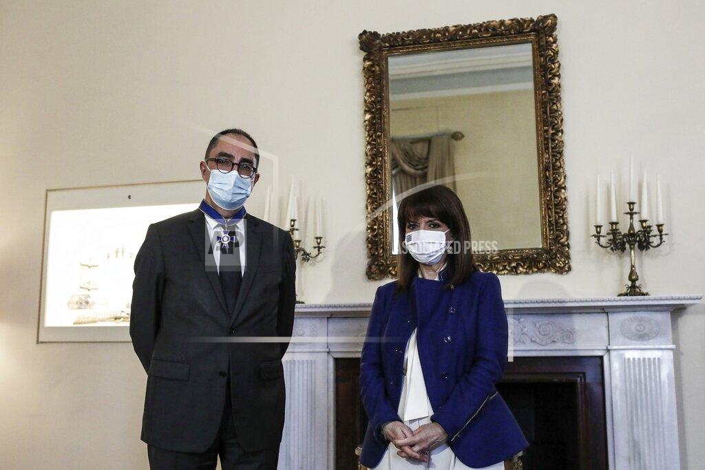 Theodore Manolopoulos In this photo provided by the Greek President's office, Greece's President Katerina Sakellaropoulou, left, poses with Louvre Museum Director Jean-Luc Martinez after she awarded him with a medal of honor at the Presidential Palace in Athens, Wednesday, March 24, 2021. The military parade on March 25, marking 200-years since the war that resulted in Greece's independence from the Ottoman Empire and rebirth as a nation, will be held without spectators due to the coronavirus, and only Greek and foreigners political officials. (Theodore Manolopoulos/Presidency of Hellenic Republic via AP)