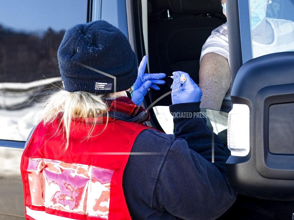 Geoff Forester A New Hamsphire resident gets ready to receive the Johnson & Johnson one-dose COVID-19 vaccine at the New Hampshire Motor Speedway in Loudon, N.H. on Saturday, March 6, 2021. The state hopes to have 12,000 residents vaccinated by Monday afternoon at the site. (Geoff Forester/The Concord Monitor via AP)