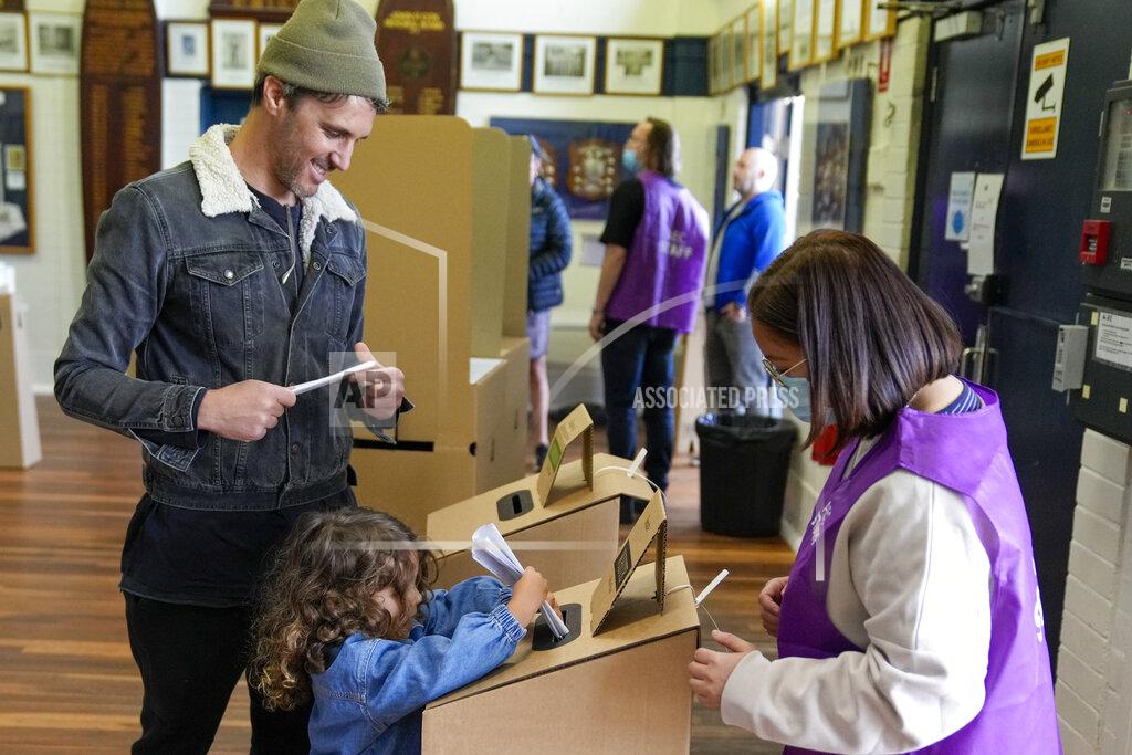 Mark Baker A daughter helps her father cast his vote at a polling booth in Sydney, Australia, Saturday, May 21, 2022. Australians go to the polls Saturday following a six-week election campaign that has focused on pandemic-fueled inflation, climate change and fears of a Chinese military outpost being established less than 1,200 miles off Australia's shore.(AP Photo/Mark Baker)