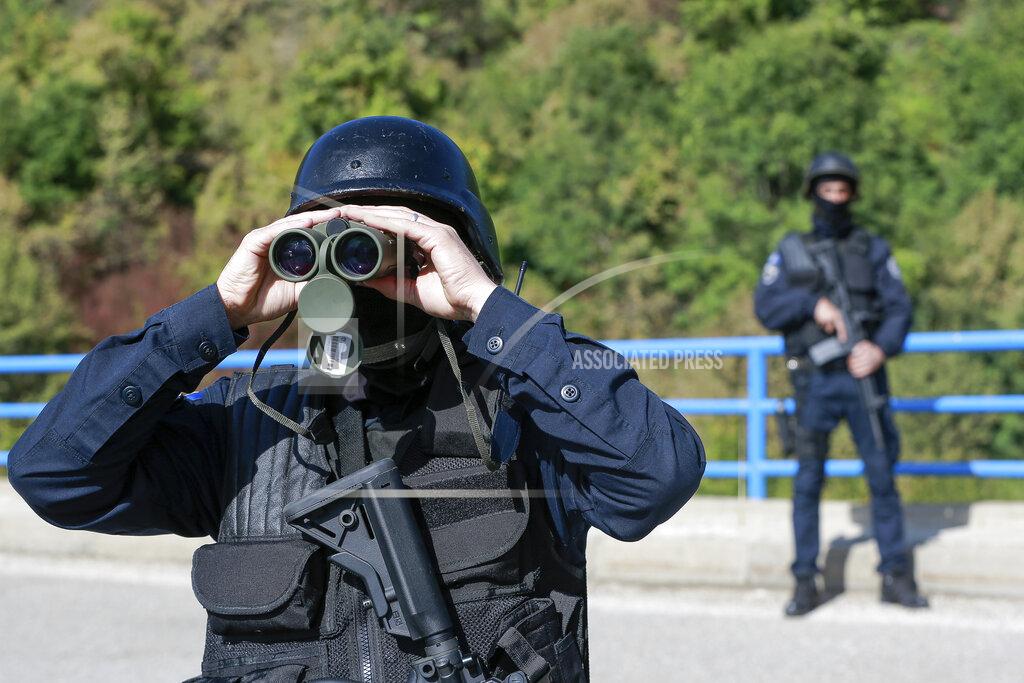 Visar Kryeziu Kosovo police officers patrol the bridge over Gazivode lake near the northern Kosovo border crossing of Brnjak on the fifth day of protest on Friday, Sept. 24, 2021. Ethnic Serbs in Kosovo have been blocking the border for a fifth straight day to protest a decision by Kosovo authorities to start removing Serbian license plates from cars entering the country, raising fears such incidents could unleash much deeper tensions between the two Balkan foes.(AP Photo/Visar Kryeziu)