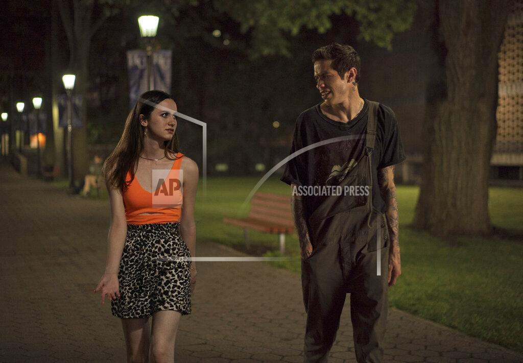 Uncredited In this image released by Universal Pictures, Maude Apatow, left, and Pete Davidson appear in a scene from "The King of Staten Island," directed by Judd Apatow. (Universal Pictures via AP)