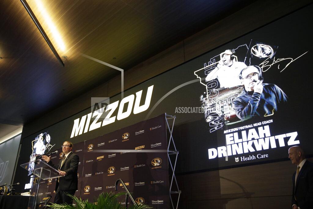 Jeff Roberson Eliah Drinkwitz speaks at a podium as he is introduced as the new NCAA college football head coach at the University of Missouri, Tuesday, Dec. 10, 2019, in Columbia, Mo. Drinkwitz becomes the 33rd head football coach at Missouri after coaching the 2019 season at Appalachian State. (AP Photo/Jeff Roberson)