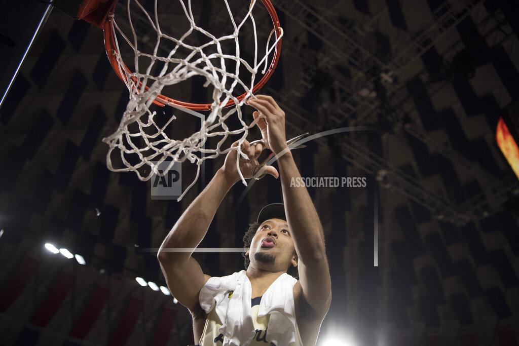 Lee Luther Jr. Liberty guard Darius McGhee takes his turn cutting down the net after defeating Lipscomb in the Atlantic Sun Conference NCAA basketball championship game in Lynchburg, Va., Sunday, March 8, 2020. (AP Photo/Lee Luther Jr.)