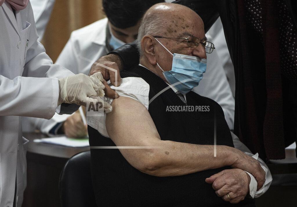 Khalil Hamra Former Palestinian Health Minister Riyad al-Zanoun receives a shot of the Russian-made Sputnik V coronavirus vaccine, in Gaza City, Monday, Feb. 22, 2021. (AP Photo/Khalil Hamra)