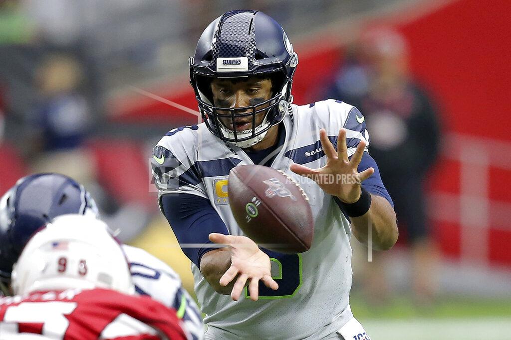 Ross D. Franklin Seattle Seahawks quarterback Russell Wilson takes the snap against the Arizona Cardinals during the first half of an NFL football game, Sunday, Sept. 29, 2019, in Glendale, Ariz. (AP Photo/Ross D. Franklin)