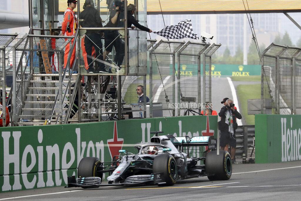 Ng Han Guan Mercedes driver Lewis Hamilton of Britain drives past the checkered flag to win the Chinese Formula One Grand Prix at the Shanghai International Circuit in Shanghai on Sunday, April 14, 2019. (AP Photo/Ng Han Guan)