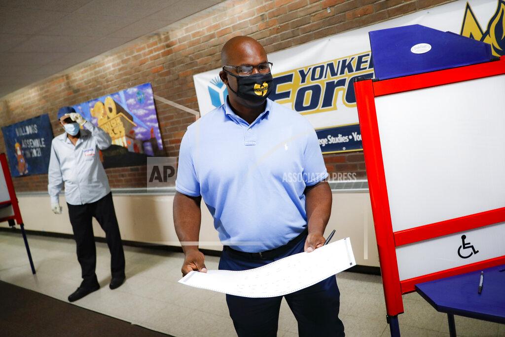 John Minchillo Jamaal Bowman votes at a polling station inside Yonkers Middle/High School, Tuesday, June 23, 2020, in Yonkers, N.Y. Bowman is running against veteran Rep. Eliot Engel in the Democratic primary for New York's 16th Congressional District. (AP Photo/John Minchillo)