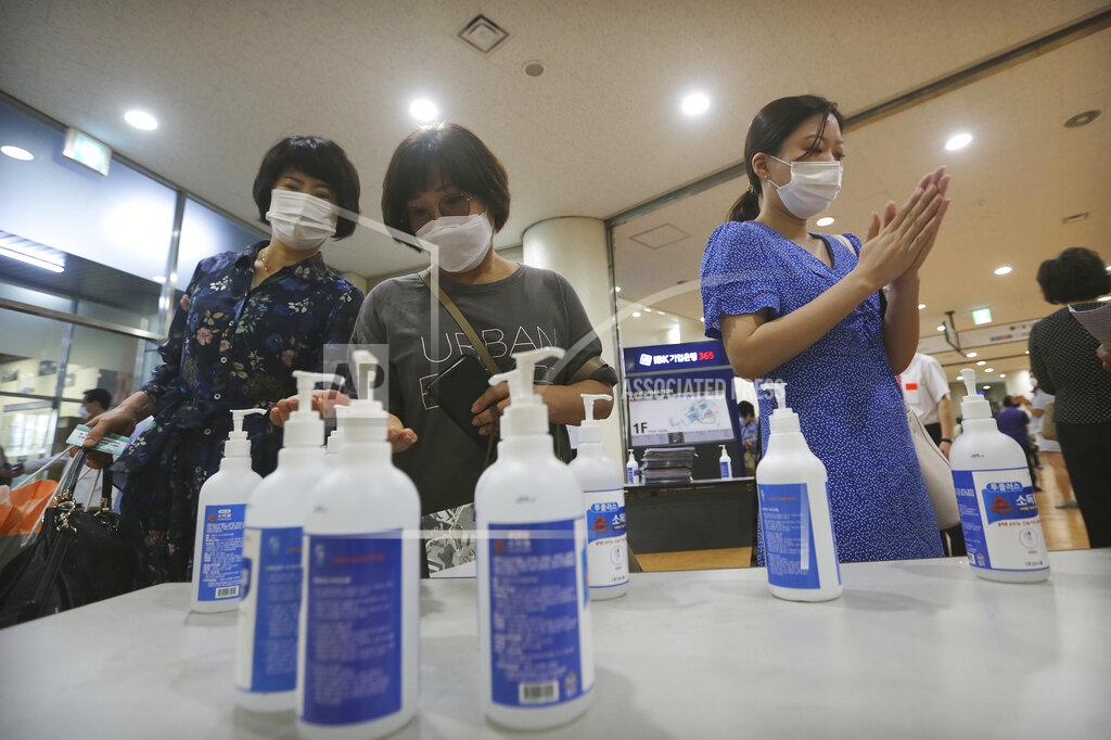 Ahn Young-Joon Christians wearing face masks to help protect against the spread of the new coronavirus use hand sanitizer before attending a service at the Yoido Full Gospel Church in Seoul, South Korea, Sunday, July 5, 2020. (AP Photo/Ahn Young-joon)