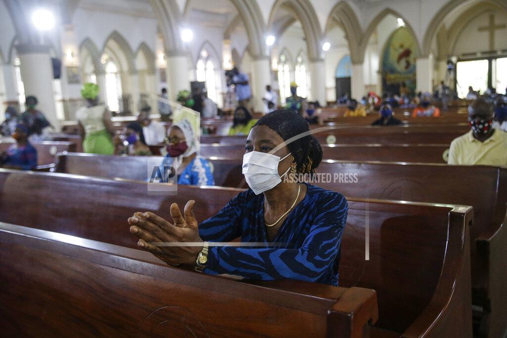 Sunday Alamba A churchgoer wears a face mask and practises social-distancing to curb the spread of the coronavirus during a Sunday mass at the Holy Cross Cathedral in Lagos, Nigeria Sunday, Aug. 30, 2020. The COVID-19 pandemic is testing the patience of some religious leaders across Africa who worry they will lose followers, and funding, as restrictions on gatherings continue. (AP Photo/Sunday Alamba)