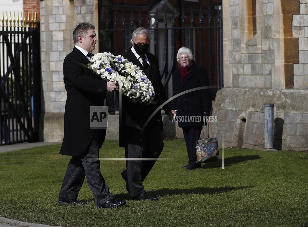 Alastair Grant Andre and Stan Walker lay a floral wreath for Prince Philip outside Windsor Castle in Windsor, England, Friday, April 16, 2021. Prince Philip husband of Britain's Queen Elizabeth II died April 9, aged 99, his funeral will take place Saturday at Windsor Castle in St George's Chapel. (AP Photo/Alastair Grant)