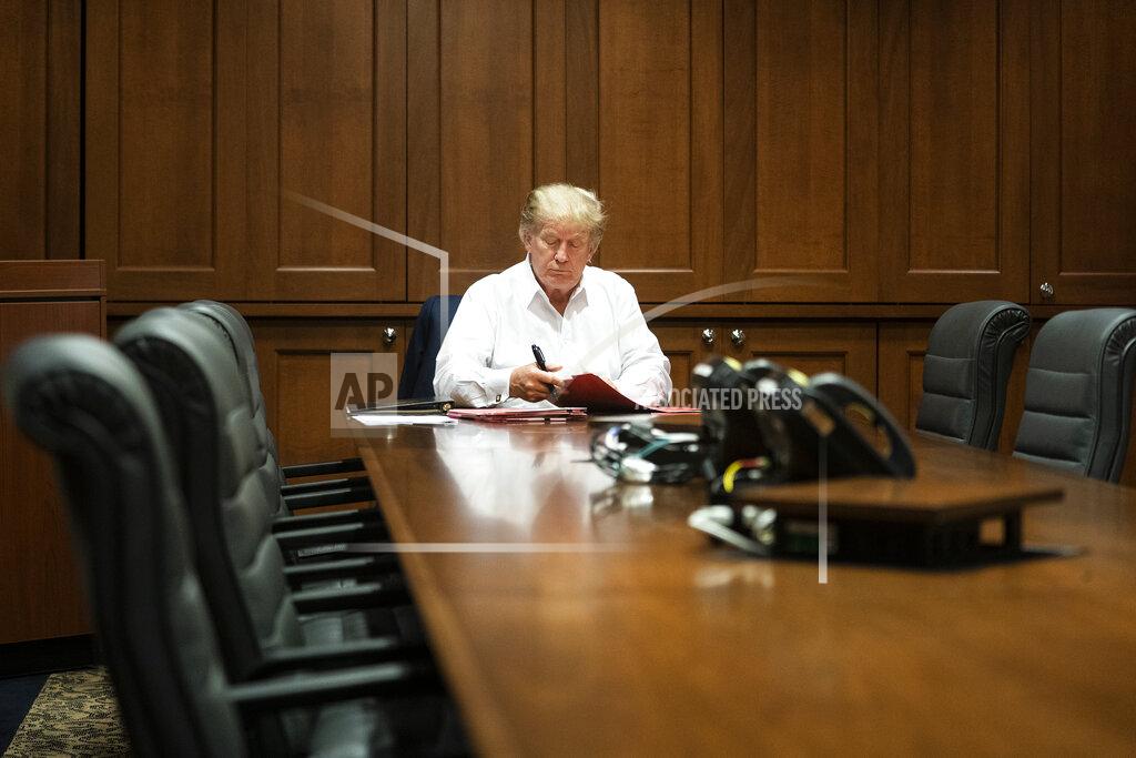 Joyce N. Boghosian In this image released by the White House, President Donald Trump works in his conference room at Walter Reed National Military Medical Center in Bethesda, Md., Saturday, Oct. 3, 2020, after testing positive for COVID-19. (Joyce N. Boghosian/The White House via AP)