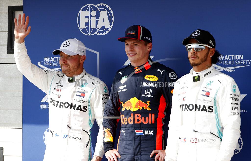 Laszlo Balogh Red Bull driver Max Verstappen of the Netherland's, center, Mercedes driver Valtteri Bottas of Finland, left, and Mercedes driver Lewis Hamilton of Britain stand on the podium after qualification for the Hungarian Formula One Grand Prix at the Hungaroring racetrack in Mogyorod, northeast of Budapest, Hungary, Saturday, Aug. 3, 2019. Red Bull driver Max Verstappen of the Netherland's will take his first career pole position in the Hungarian Formula One Grand Prix on Sunday. (AP Photo/Laszlo Balogh)