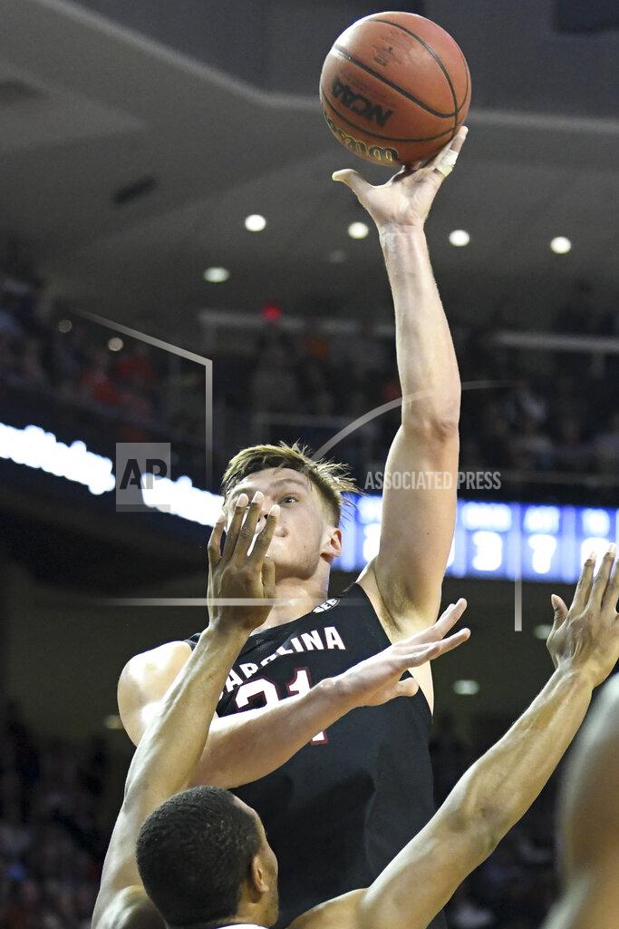 Julie Bennett South Carolina forward Maik Kotsar (21) shoots over Auburn forward Anfernee McLemore (24) during the first half of an NCAA college basketball game Wednesday, Jan. 22, 2020, in Auburn, Ala. (AP Photo/Julie Bennett)