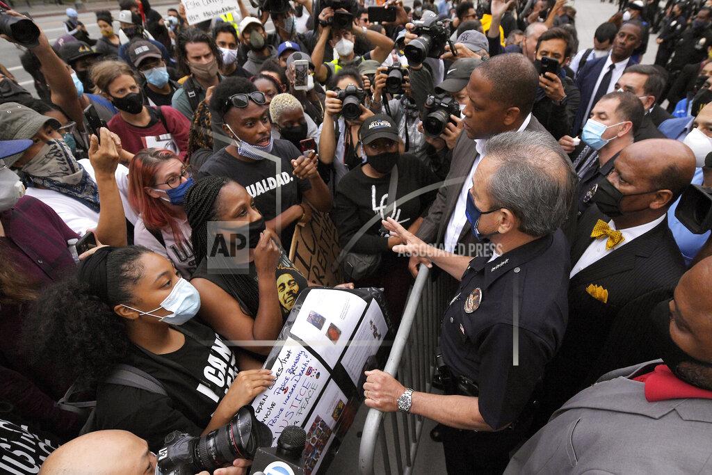 Mark J. Terrill Los Angeles police chief Michel Moore speaks to protesters after a vigil with members of professional associations and the interfaith community at Los Angeles Police Department headquarters, Friday, June 5, 2020, in Los Angeles. (AP Photo/Mark J. Terrill)