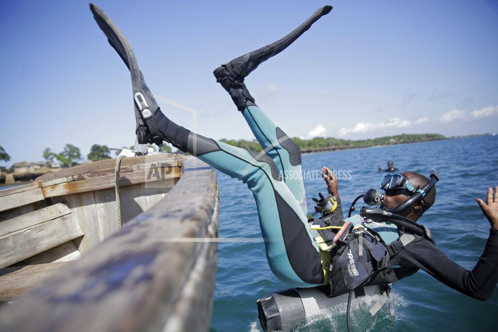 Brian Inganga Coral reef restoration ranger Dosa Mshenga Mchambi heads into the Indian Ocean to place artificial reef structure near Shimoni, Kenya on Tuesday, June 14, 2022. The marine area off the coast of Kenya at Wasini Island, jointly managed by a foundation and the island's community, has been planting over 8,000 corals a year since 2010 and placed about 800 artificial reef structures in the channel in a bid to restore Wasini's coral gardens. (AP Photo/Brian Inganga)