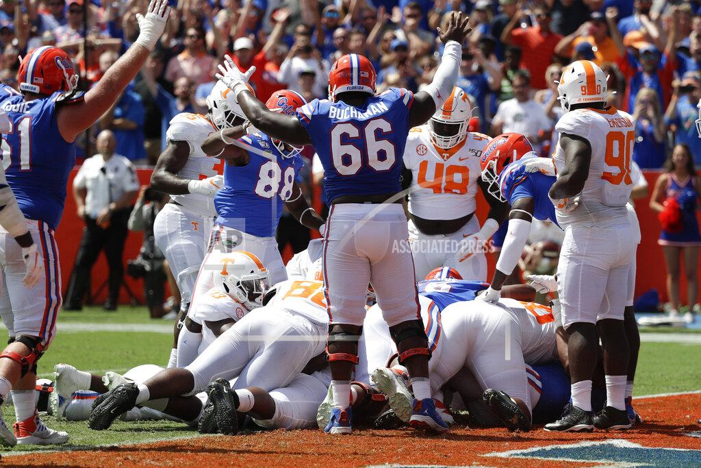 John Raoux Florida players, including tight end Kemore Gamble (88) and offensive lineman Nick Buchanan (66) signal a touchdown as running back Lamical Perine scores in the pileup at the goal line during the first half of an NCAA college football game, Saturday, Sept. 21, 2019, in Gainesville, Fla. (AP Photo/John Raoux)