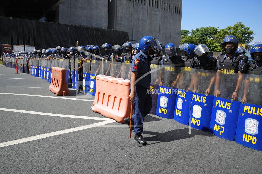 Aaron Favila Police form a blockade against protesters during a rally against presidential frontrunner Ferdinand "Bongbong" Marcos and running mate Sara Duterte, daughter of the current president, during a rally in Pasay City, Philippines on Friday, May 13, 2022. Allies of the Philippines' presumptive next president, Ferdinand "Bongbong" Marcos Jr., appear set to strongly dominate both chambers of Congress, further alarming activists after the late dictator's son scored an apparent election victory that will restore his family to the seat of power. (AP Photo/Aaron Favila)
