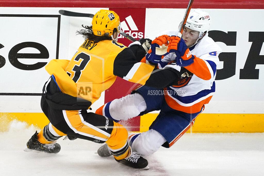 Gene J. Puskar Pittsburgh Penguins' Brandon Tanev, left, checks New York Islanders' Noah Dobson off his skates during the first period in Game 1 of an NHL hockey Stanley Cup first-round playoff series in Pittsburgh, Sunday, May 16, 2021. (AP Photo/Gene J. Puskar)
