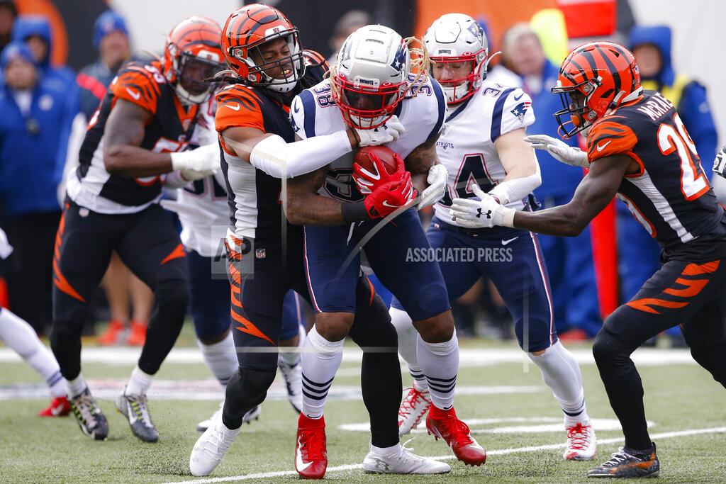 Gary Landers New England Patriots running back Brandon Bolden (38) is tackled by Cincinnati Bengals cornerback Darius Phillips, center left, in the first half of an NFL football game, Sunday, Dec. 15, 2019, in Cincinnati. (AP Photo/Gary Landers)