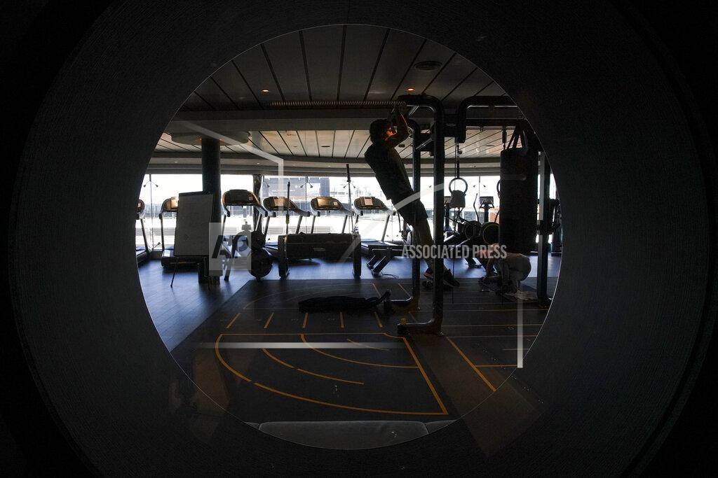 Andrew Medichini A man exercises in a gym on the MSC Grandiosa cruise ship in Civitavecchia, near Rome, Wednesday, March 31, 2021. MSC Grandiosa, the world's only cruise ship to be operating at the moment, left from Genoa on March 30 and stopped in Civitavecchia near Rome to pick up more passengers and then sail toward Naples, Cagliari, and Malta to be back in Genoa on April 6. For most of the winter, the MSC Grandiosa has been a lonely flag-bearer of the global cruise industry stalled by the pandemic, plying the Mediterranean Sea with seven-night cruises along Italy’s western coast, its major islands and a stop in Malta. (AP Photo/Andrew Medichini)