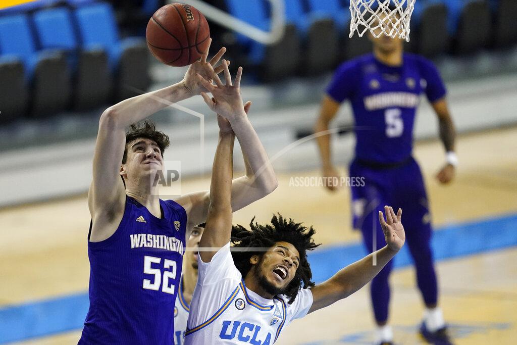 Ashley Landis UCLA guard Tyger Campbell, right, breaks up a shot by Washington center Riley Sorn (52) during the first half of an NCAA college basketball game Saturday, Jan. 16, 2021, in Los Angeles. (AP Photo/Ashley Landis)
