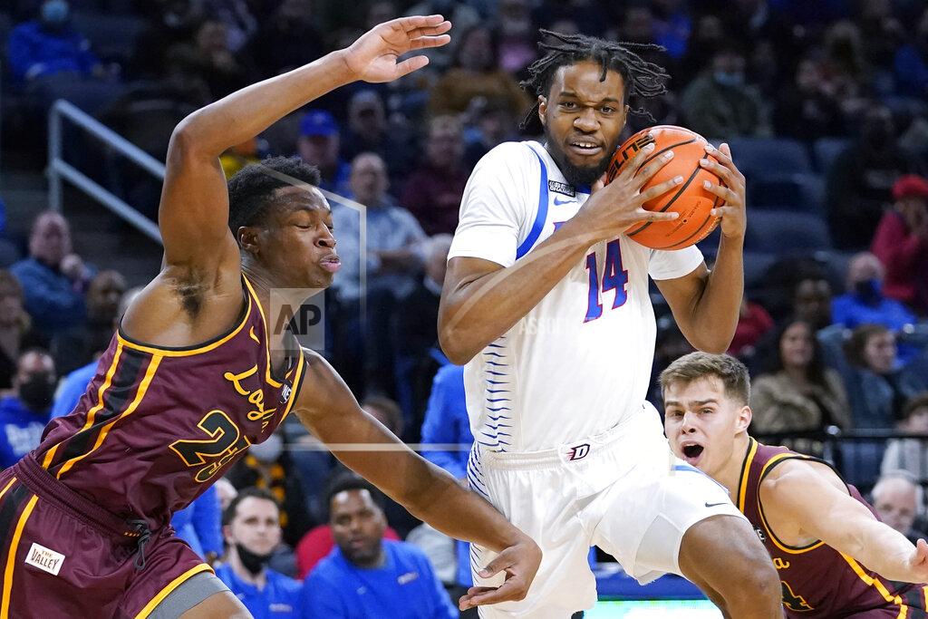 Nam Y. Huh DePaul center Nick Ongenda, front right, drives to the basket against Loyola forward Chris Knight, left, during the second half of an NCAA college basketball game in Chicago, Saturday, Dec. 4, 2021. (AP Photo/Nam Y. Huh)