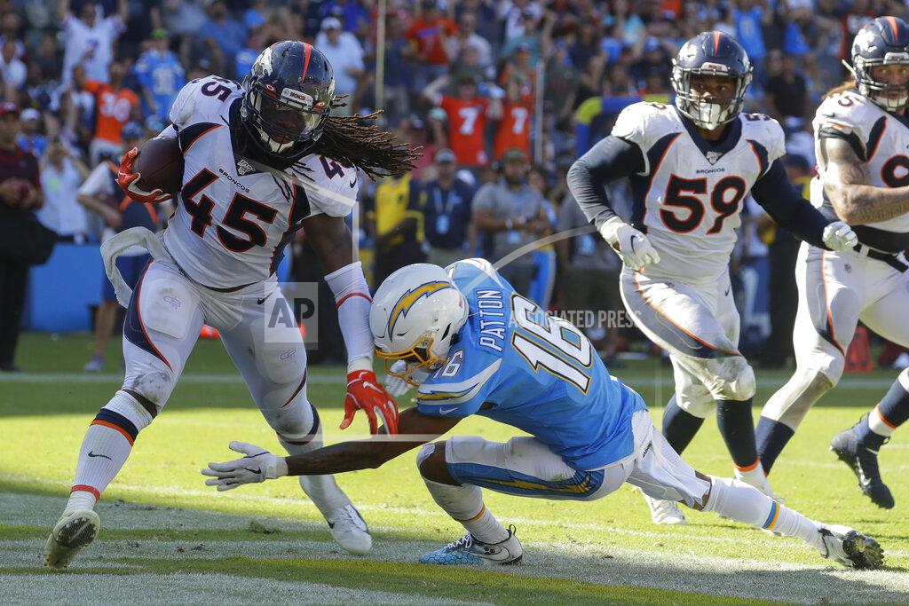 Alex Gallardo Denver Broncos linebacker A.J. Johnson, left, is tackled by Los Angeles Chargers wide receiver Andre Patton after an interception in the end zone during the second half of an NFL football game Sunday, Oct. 6, 2019, in Carson, Calif. (AP Photo/Alex Gallardo)