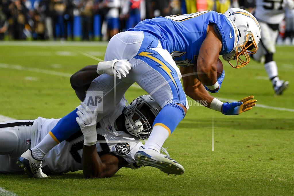 Kelvin Kuo Los Angeles Chargers running back Austin Ekeler is tackled by Oakland Raiders linebacker Nicholas Morrow during the first half of an NFL football game Sunday, Dec. 22, 2019, in Carson, Calif. (AP Photo/Kelvin Kuo)