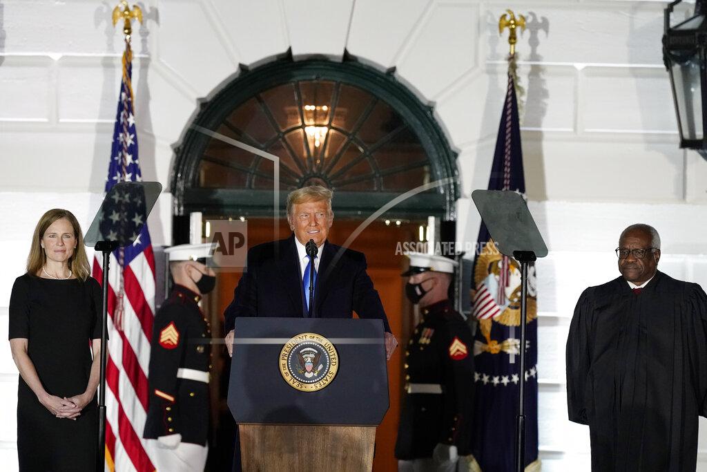 Alex Brandon President Donald Trump speaks before Supreme Court Justice Clarence Thomas administers the Constitutional Oath to Amy Coney Barrett on the South Lawn of the White House White House in Washington, Monday, Oct. 26, 2020, after Barrett was confirmed to be a Supreme Court justice by the Senate earlier in the evening. (AP Photo/Alex Brandon)