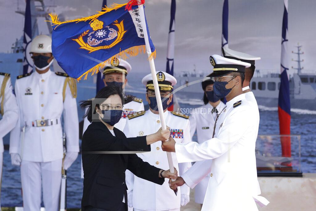 Chiang Ying-Ying Taiwan's President Tsai Ing-wen, left, presents a flag during the commissioning ceremony of the the domestically made Ta Jiang warship at the Suao naval base in Yilan county, Taiwan, Thursday, Sept. 9, 2021. Taiwan's president oversaw the commissioning of a new domestically made navy warship Thursday as part of the island's plan to boost indigenous defense capacity amid heightened tensions with China. (AP Photo/Chiang Ying-ying)
