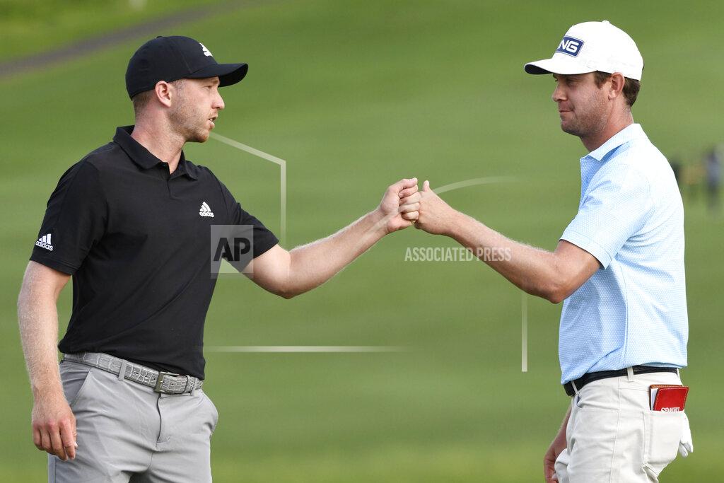 Matthew Thayer Harris English, right, greets Daniel Berger on the 18th green during the third round of the Tournament of Champions golf event, Saturday, Jan. 9, 2021, at Kapalua Plantation Course in Kapalua, Hawaii. (Matthew Thayer/The Maui News via AP)