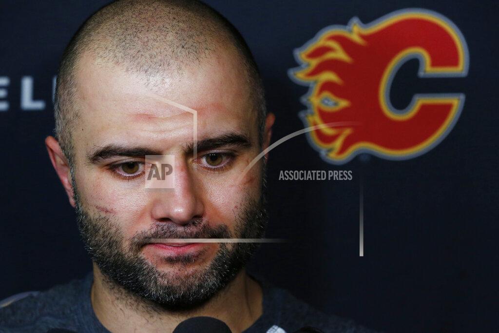 Jeffrey T. Barnes Calgary Flames Mark Giordano addresses the media following NHL hockey practice Tuesday, Nov. 26, 2019, in Buffalo, N.Y. Flames general manager Brad Treliving says coach Bill Peters remains on the staff but wasn’t certain whether he’d be behind the bench for the next game. The team and the NHL are both investigating an allegation the Peters directed racial slurs at a player 10 years ago when the two were in the minors. Akim Aliu, a Nigerian-born player, says Peters “dropped the N bomb several times” in a dressing room during his rookie year. (AP Photo/Jeffrey T. Barnes)