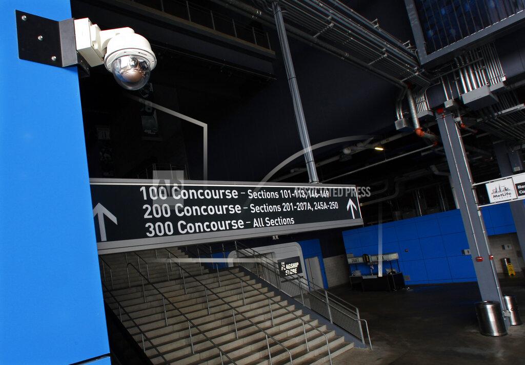 Mel Evans FILE - In this Oct. 15, 2014, file photo, a security camera, upper left, is mounted near a stairway at MetLife Stadium, home of the New York Giants and the New York Jets football teams, in East Rutherford, N.J. Dave Karls has Bucks season tickets and is eager enough for his next visit to Fiserv Forum that having his location trackable in the arena would not interfere with the enjoyment. “I’d much rather have that than not be able to attend the game at all,” Karls said. Such concern depends on an individual's definition of surveillance, a word that carries nefarious connotation in some corners. (AP Photo/Mel Evans, File)