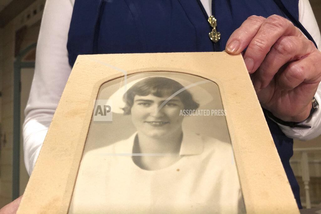 Haven Daley Nurse practitioner Sigrid Stokes, 76, holds a photograph of her mother at the Salinas Valley Memorial Hospital in Salinas, Calif., Wednesday, Feb. 3, 2021. Stokes is following in her family's footsteps during the pandemic. In 1918, Stokes' mother Kristine Berg Mueller was a 14-year-old hospital volunteer in Norway during the Spanish Flu pandemic, putting her in regular contact with the deadly disease. (AP Photo/Haven Daley)