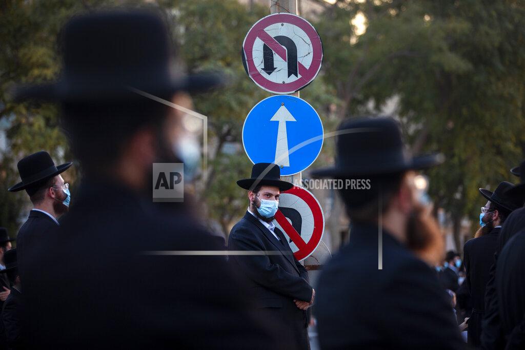 Ultra-Orthodox Jews wear face masks and keep social distancing amid concerns over the country's coronavirus outbreak, during a protest to what they say is incitement against the city and country's religious population in the southern Israel city of Arad, Israel, Monday, Oct. 19, 2020. (AP Photo/Oded Balilty)