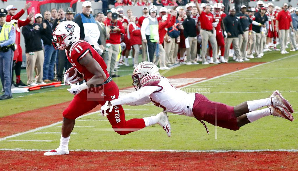 Chris Seward North Carolina State's Jakobi Meyers (11) evades Florida State's A.J. Westbrook (19) to score a touchdown during the second half of an NCAA college football game in Raleigh, N.C., Saturday, Nov. 3, 2018. (AP Photo/Chris Seward)