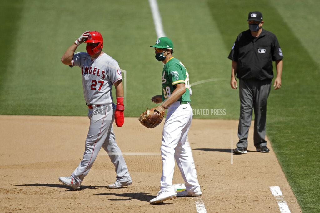 Ben Margot Oakland Athletics' Matt Olson (28) wears a mask as Los Angeles Angels' Mike Trout, left, also wears one while taking a lead off first base during the eighth inning of a baseball game Monday, July 27, 2020, in Oakland, Calif. (AP Photo/Ben Margot)