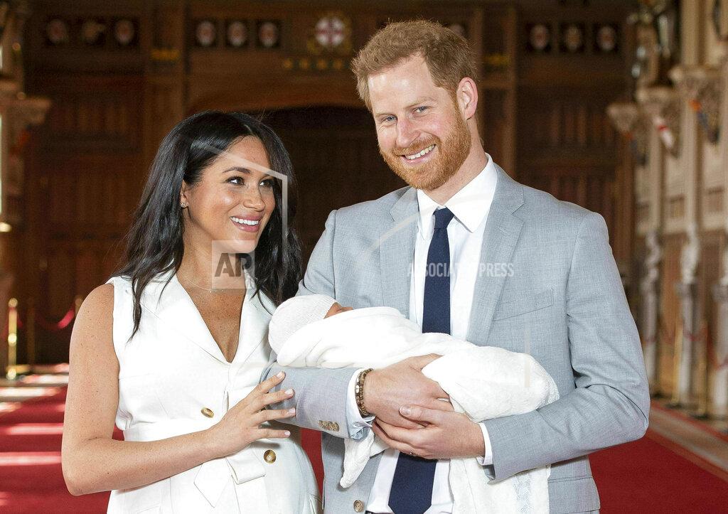 Dominic Lipinski FILE - In this Wednesday May 8, 2019 file photo, Britain's Prince Harry and Meghan, Duchess of Sussex, during a photocall with their newborn son Archie, in St George's Hall at Windsor Castle, Windsor, south England. In a stunning declaration, Britain’s Prince Harry and his wife, Meghan, said they are planning “to step back” as senior members of the royal family and “work to become financially independent.” A statement issued by the couple Wednesday, Jan. 8, 2020 also said they intend to “balance” their time between the U.K. and North America (Dominic Lipinski/Pool via AP, file)